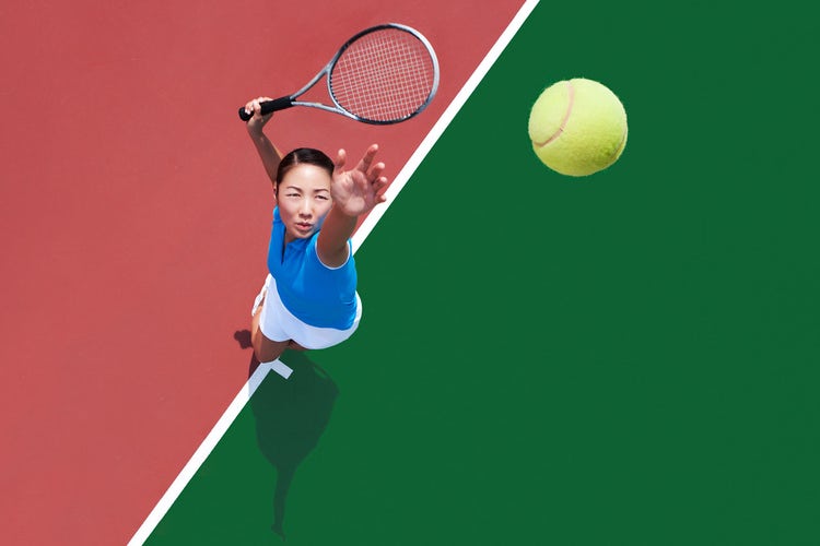 Overhead shot of a tennis player throwing a ball in the air to serve it