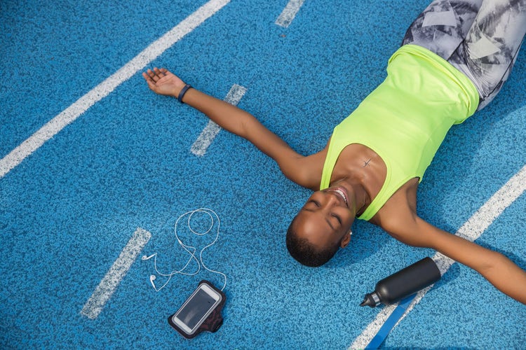 woman-lying-on-running-track