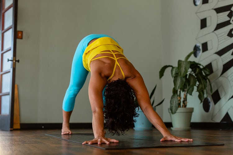 A person practices downward facing dog