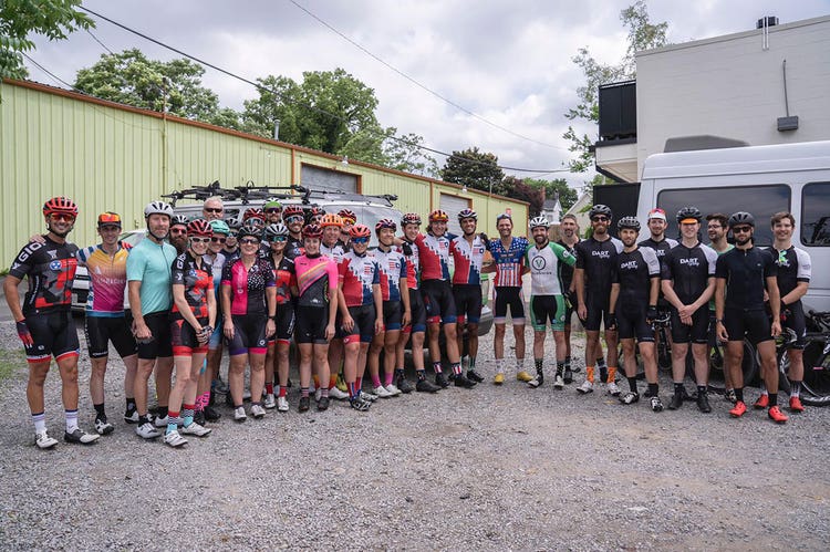 Phil Gaimon poses with a large group of cyclists
